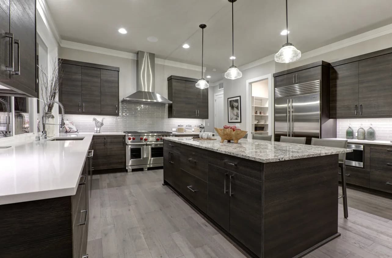 Modern dark slate flat-panel kitchen with white quartz waterfall island and glass pendants - photo 1