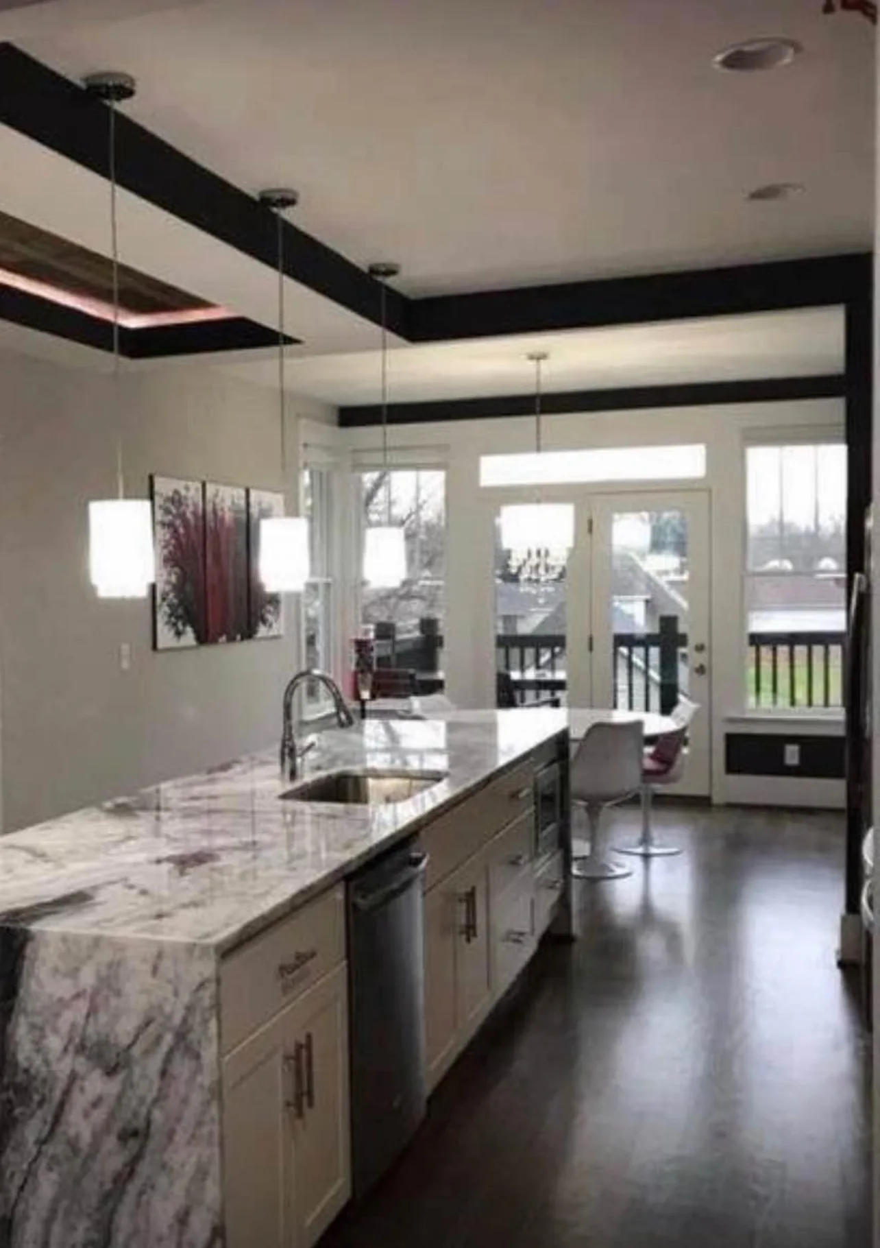 White shaker kitchen with marble waterfall island and coffered ceiling beams - photo 1