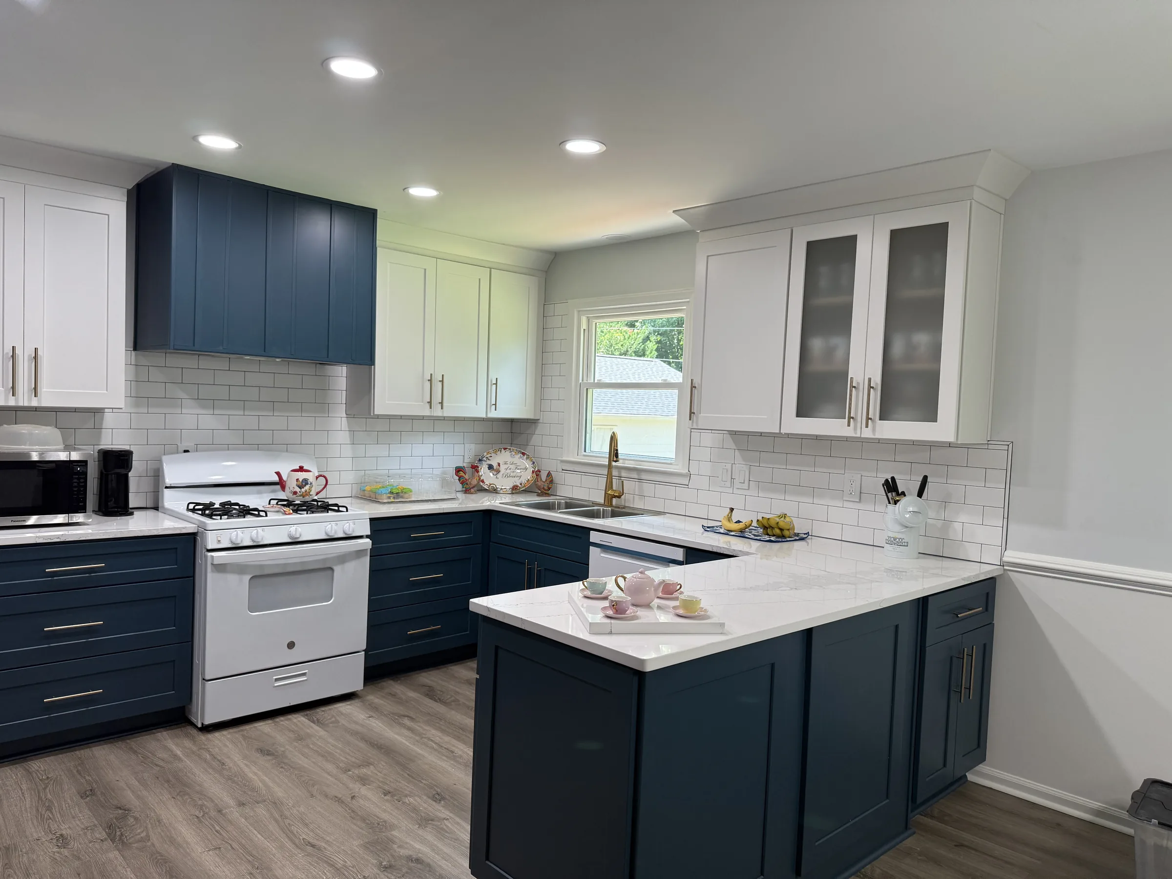 Navy and white two-tone shaker kitchen with gold hardware and quartz peninsula - photo 1